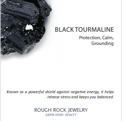 Black tourmaline crystal with text on a white background