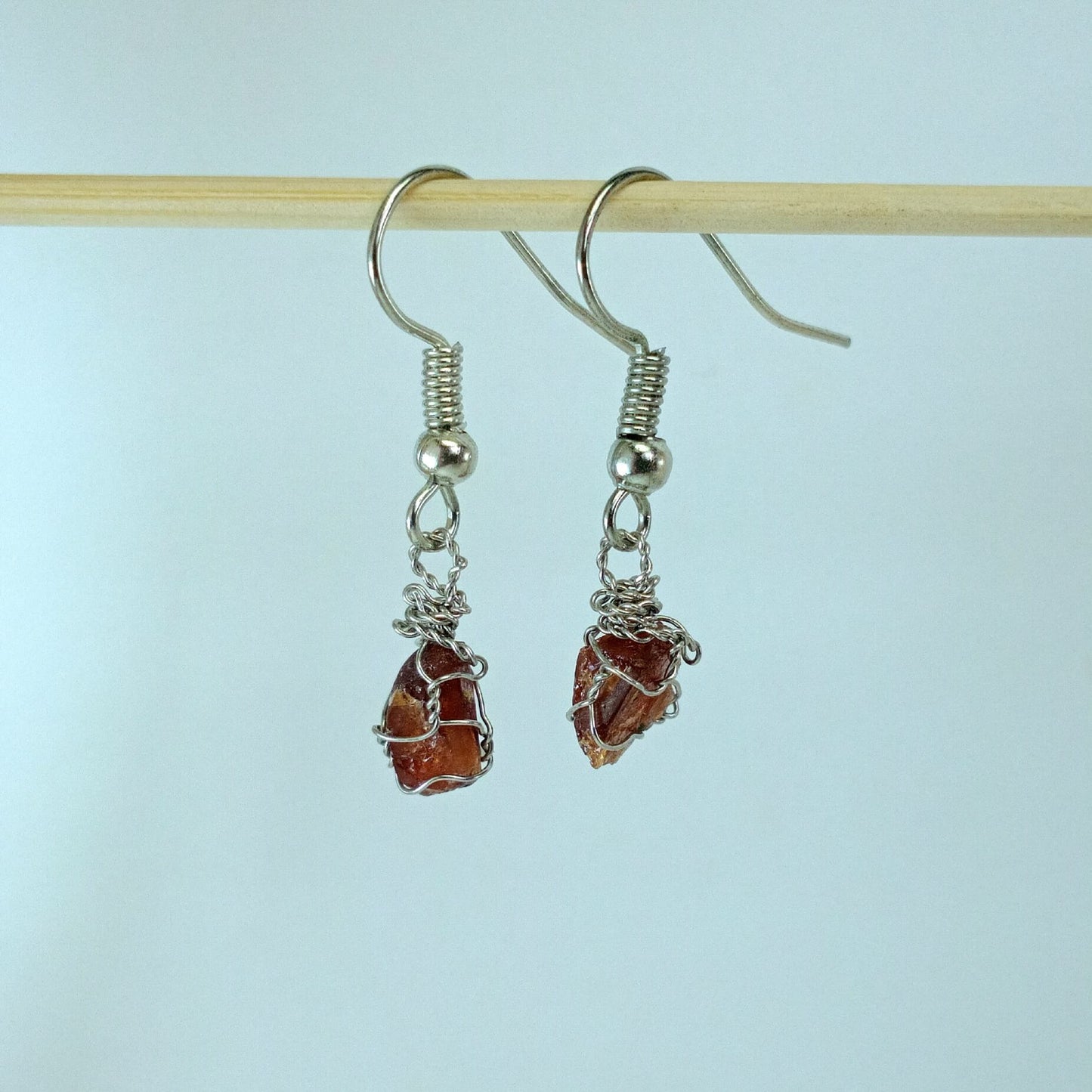 Garnet stones earrings with descriptive text on a white background