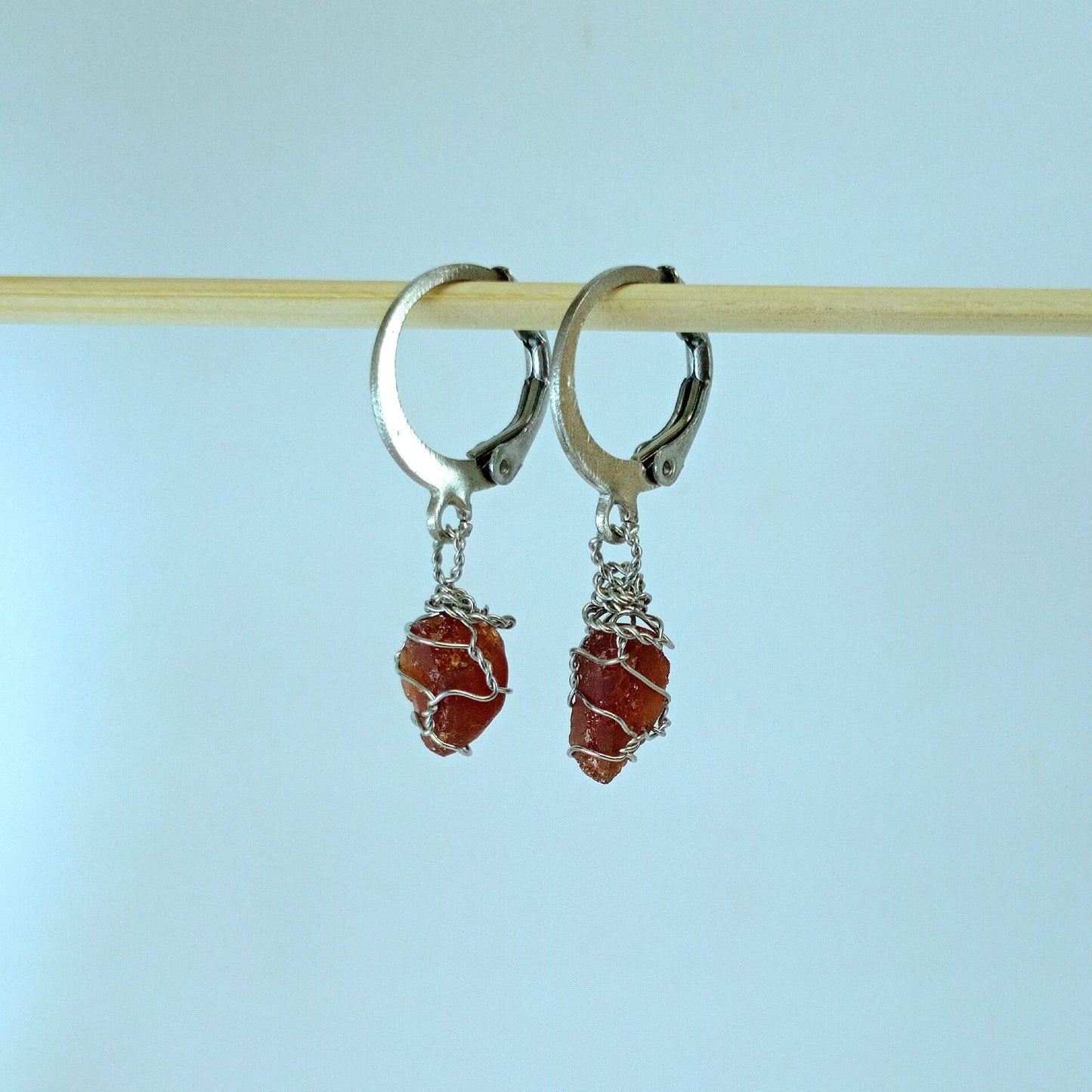 Garnet stone earrings with descriptive text on a white background
