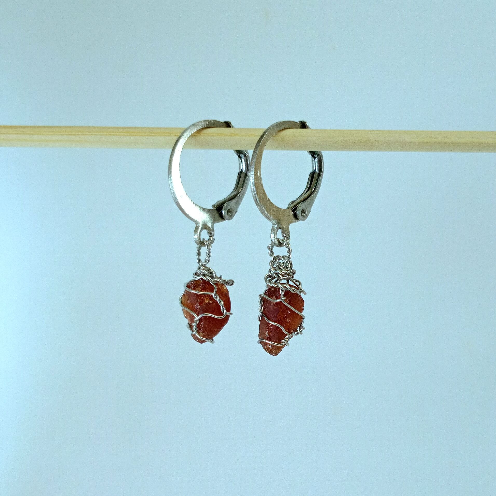 Garnet stone earrings with descriptive text on a white background
