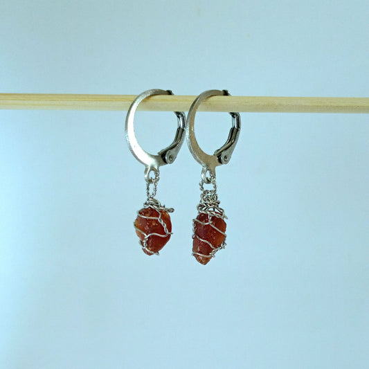 Garnet stone earrings with descriptive text on a white background