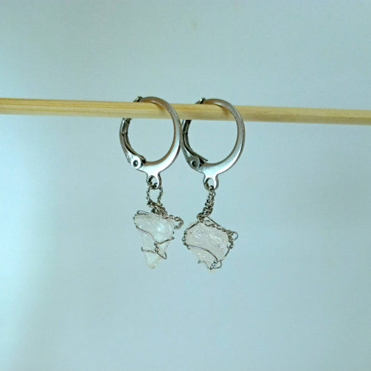 Silver hoop earrings with Rose Quartz on a light blue background