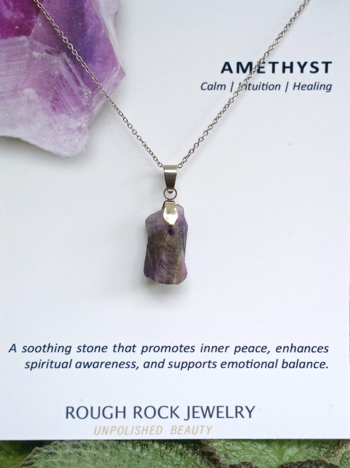 Amethyst pendant necklace with amethyst crystal on a white background, featuring text about the stone's properties.