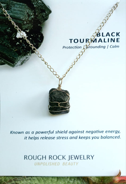 Black tourmaline necklace with stone pendant on a white background, featuring Rough Rock Jewelry branding.