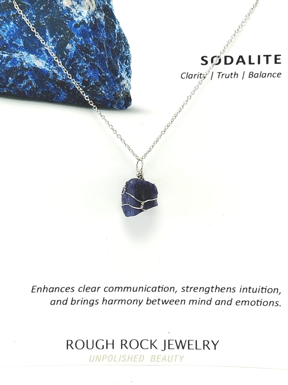 Necklace with sodalite pendant on a white background, featuring text about sodalite properties.